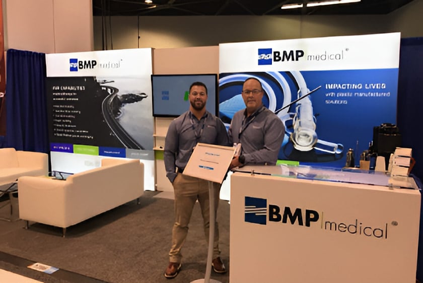 BMP Medical representatives standing at a trade show booth.